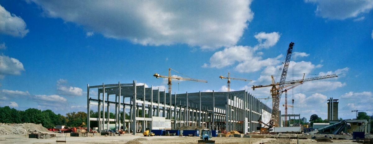 Commercial construction site with steel framing and cranes
