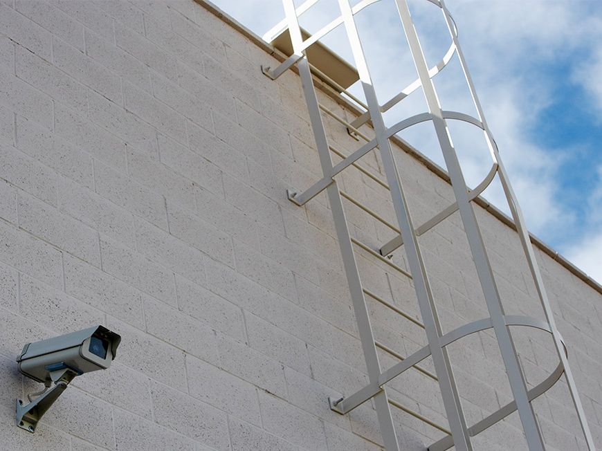 Bullet security camera mounted on an exterior block wall