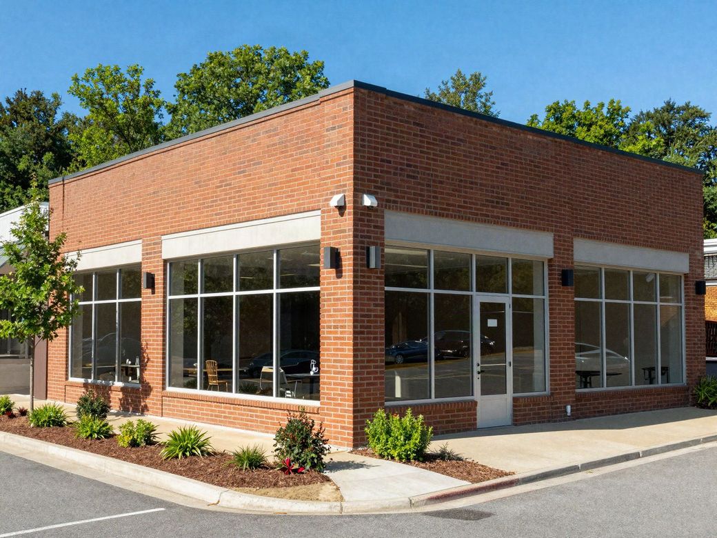 Brick and glass commercial building with an exterior security camera on a sunny morning